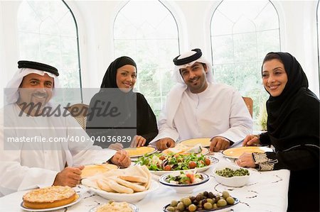 A Middle Eastern family enjoying a meal in a restaurant