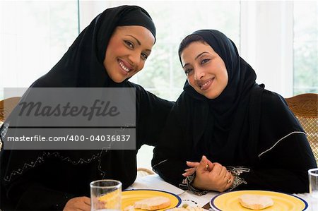 Two Middle Eastern women enjoying a meal