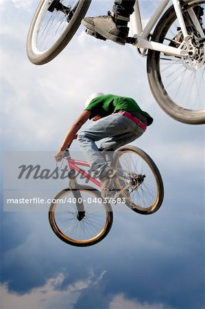 Two BMX bikers high up in the air.  Some motion blur on both bikers.