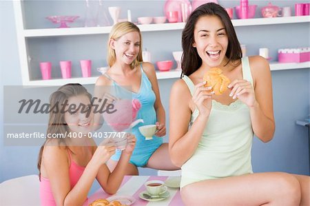 Three young women in their underwear having a tea party