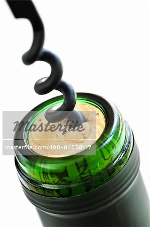 Opening wine bottle with a corkscrew on white background