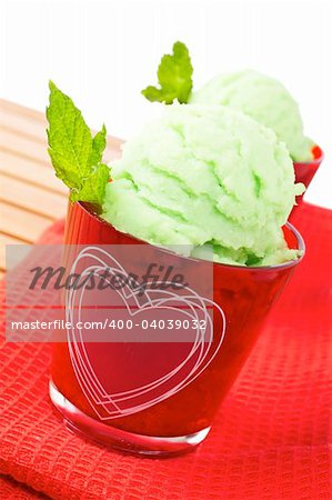 Delicious mint ice cream in red glass bowl. Shallow depth of field