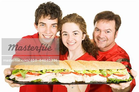 Football fans holding a giant submarine sandwich.  Isolated on white.