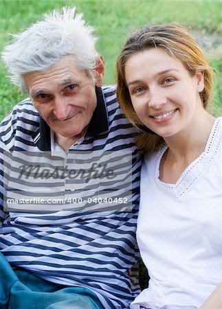 Family portrait - senior man with his beautiful granddaughter