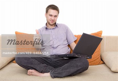 casual man sitting on sofa with laptop