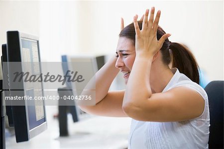 Woman in computer room looking frustrated