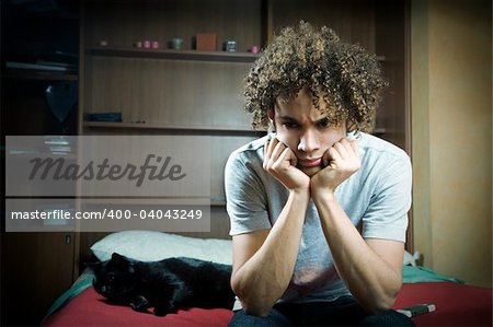 Young Brazilian teenager sad and upset in bedroom