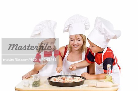 Little boy and girl with their mother preparing a pizza - isolated