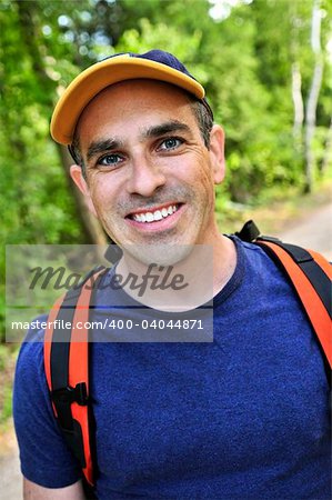 Portrait of happy middle aged man on a forest trail