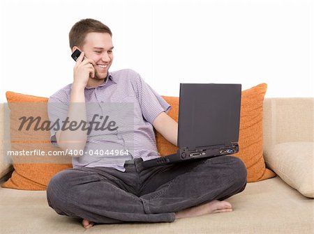 casual guy sitting on sofa with laptop