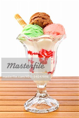 Delicious multi flavor ice cream glass on wooden background. Shallow depth of field