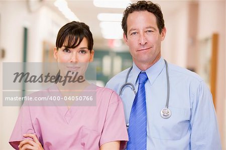Doctor And Nurse Standing In A Hospital Corridor