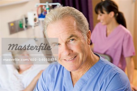 Doctor Standing In Patients Room,Nurse Checking Up On Patient