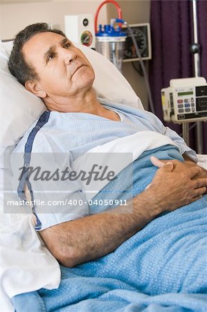 Middle Aged Man Lying In Hospital Bed