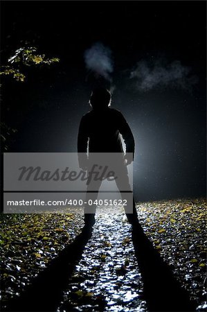 Siluette of man in the forest on the night