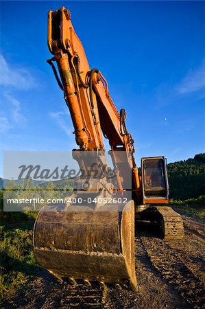 A big orange bulldozer at construction site