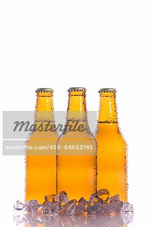 Three isolated cool beers with ice