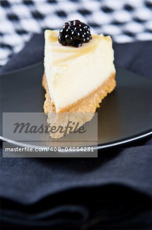 Delicious homemade lemon cheesecake on a black plate