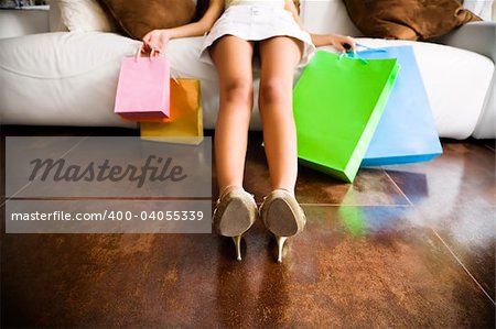 Woman relaxing on couch after long day shopping
