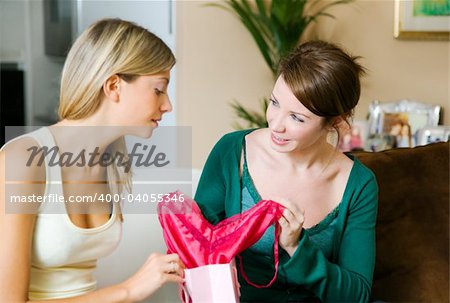 Friends looking at fuchsia underwear together