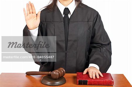 A female judge taking oath in a courtroom, isolated on white background. Shallow depth of field