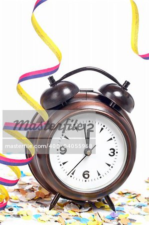 Waiting the New Year with clock, confetti and ribbons. Shallow depth of field