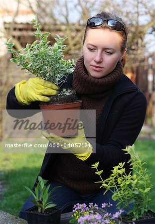 woman with green herbs in garden