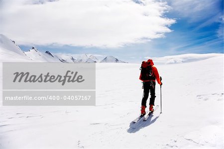Lone Alpine Touring Skier on the big Verra Glacier; in background the peaks of Castore and Polluce. MonteRosa, Swiss-Italy border.