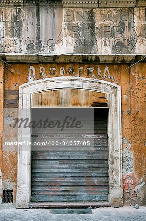old business in the ghetto neighbourhood in Roma. Wall is dirty and broken