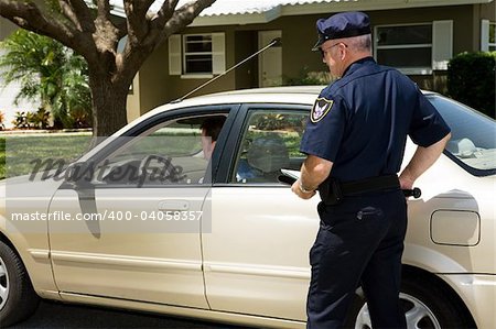 Policeman pulling over a motorist on the street.