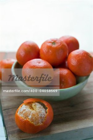 group of Tangerines in a ceramic blue bowl on a counter