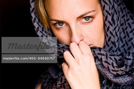 Arab woman using veil with amazing green eyes.
