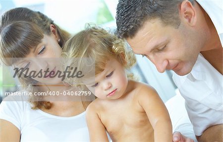 High key portrait of nice young family getting busy