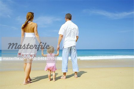 Portrait of young family having fun on the beach