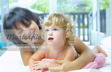 High key portrait of happy mother with baby