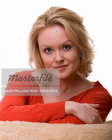 Attractive close up of face of a woman with blond hair and blue eyes with nice smile facial expression over white
