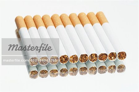 Cigarettes in a row on a mirror - white background