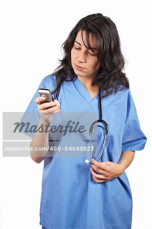 Friendly female doctor in blue scrubs with stethoscope sending sms with cell phone