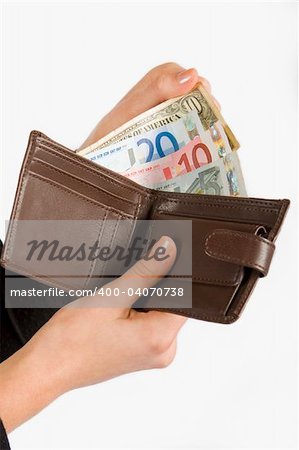 Hand holding wallet with foreign notes isolated on white