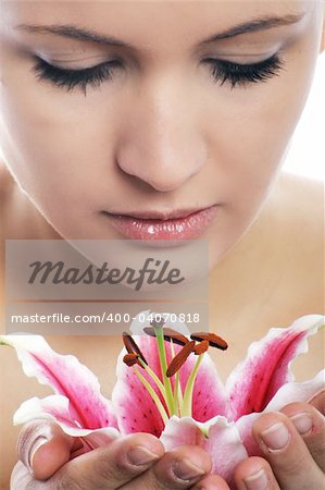 beauty portrait of a young woman isolated on white background with a flower