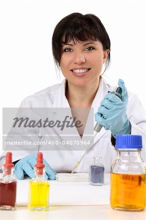 Smiling search scientist using a manual fixed volume pipette and spotting plate.  She is looking straight ahead and smiling cheerfully.