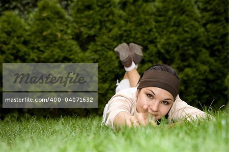 attractive brunette woman lying on grass