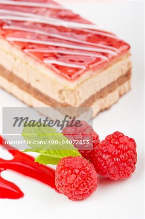 Delicious raspberries cake with soft shadow on white dish. Shallow depth of field