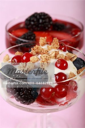 Three yogurts in the glass with fruits and cereal