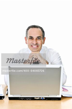 Happy businessman sitting at his desk isolated on white background