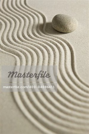 Stone on raked sand; zen concept