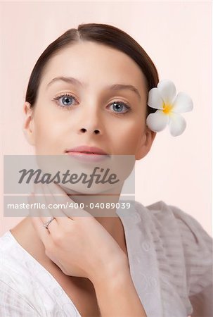 Portrait of young beautiful woman on pink background