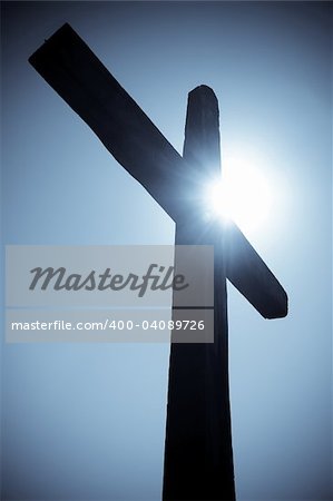 silhouette of the Christian cross against the sun