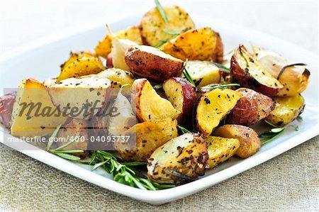 Herb roasted potatoes served on a plate