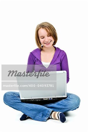 Young girl sitting cross legged with laptop computer